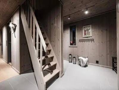 a staircase in a room with wooden walls at Modern cabin with a Mountain View in Nos