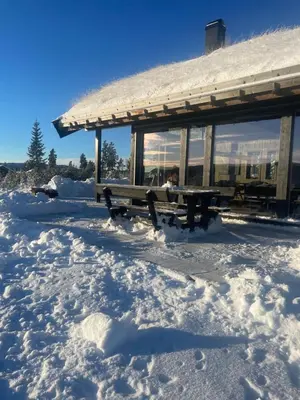 a bench in the snow in front of a building at Modern cabin with a Mountain View in Nos