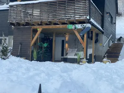 a house in the snow with a snowboard on it at Bingo apartaments in Hønefoss