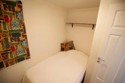 a small room with a bed and a painting on the wall at Ideal Getaway For Couples Or Small Families in Beitostøl