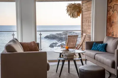 a living room with a view of the ocean at Runde Panorama - Østen Pilot in Terøy