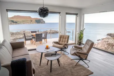 a living room with a view of the ocean at Runde Panorama - Castillo in Terøy