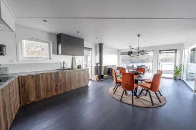 a kitchen and dining room with a table and chairs at Runde Panorama - Castillo in Terøy