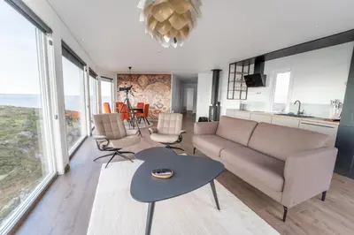 a living room with a couch and a table at Runde Panorama - Batavia Dream in Terøy