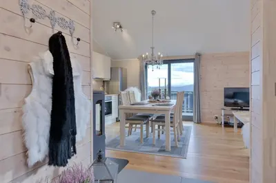 a kitchen and dining room with a table and chairs at Modern Apartment with 3 Bedrooms and Stunning View in Beitostøl