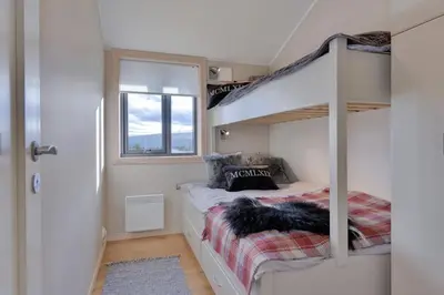 a small bedroom with a bunk bed and a window at Modern Apartment with 3 Bedrooms and Stunning View in Beitostøl