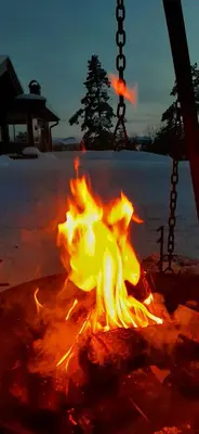 a fire in a fire pit in the snow at Stallen in Heggem