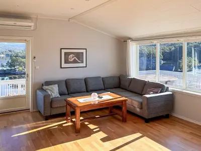 a living room with a couch and a table at 6 person holiday home in HOSTELAND in Hosteland