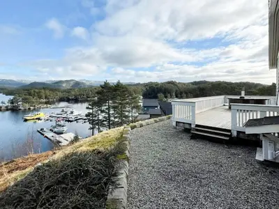 a view of a river with a dock and boats at 6 person holiday home in HOSTELAND in Hosteland