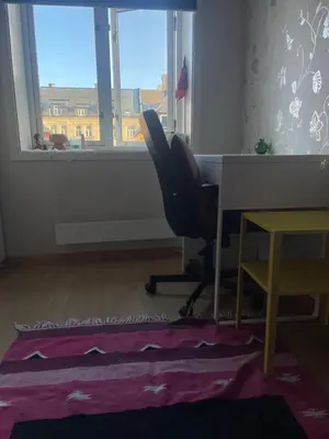 a desk and a chair in a room with a window at Cozy room near city centre in Trondheim