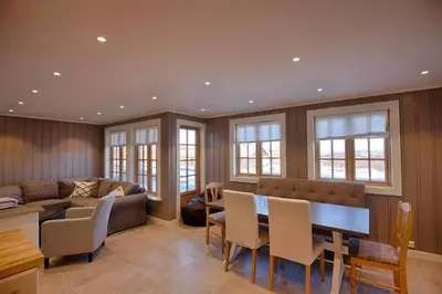 a living room with a couch and a table and chairs at Perfectly Located With Ski Access And Sauna in Beitostøl