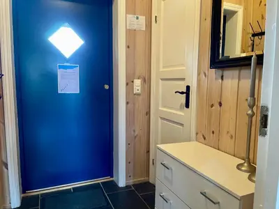 a bathroom with a blue door with a sign on it at Perfect For Skiing And City Access in Beitostøl