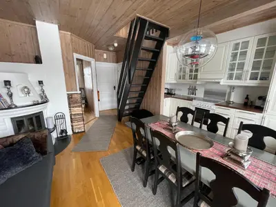 a kitchen and dining room with a table and chairs at Perfect For Skiing And City Access in Beitostøl