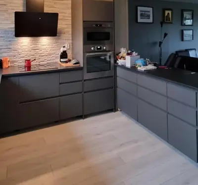 a kitchen with black counters and a stove top oven at Rekkehus med 3 soverom in Trondheim