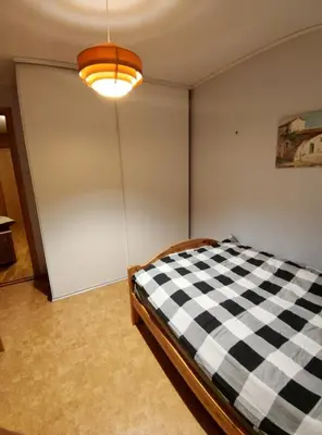a bedroom with a black and white checkered bed at Teglverket in Trondheim