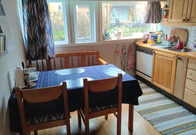 a kitchen with a table and chairs in a kitchen at Teglverket in Trondheim