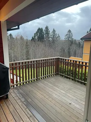 a porch with a wooden deck with a fence at Ski VM 2025 in Trondheim