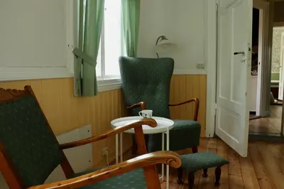 a room with two chairs and a table and a window at Sjarmerende hus i sentrum in Elverum