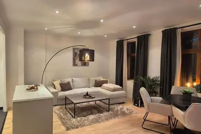 a living room with a couch and a table at Luxurious city apartment in Bergen