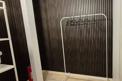 a bathroom with a black wall with graffiti on it at Luxurious city apartment in Bergen