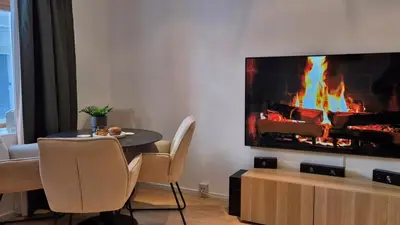 a living room with a table and a fireplace at Luxurious city apartment in Bergen