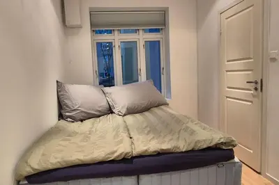 a bed in a room with a window at Luxurious city apartment in Bergen