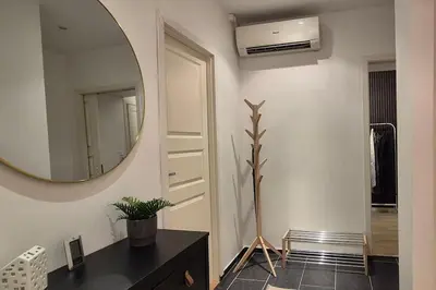 a bathroom with a mirror and a dresser and a sink at Luxurious city apartment in Bergen