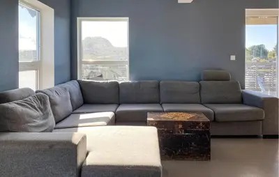 a living room with a couch and a table at Beautiful Home In Fjørtoft With Wifi in Fjørtoft
