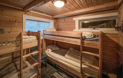 a bedroom with two bunk beds in a log cabin at Lovely Home In Beitostølen in Beitostøl