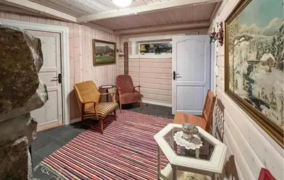 a small room with chairs and a table and a rug at Lovely Home In Beitostølen in Beitostøl