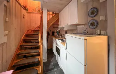 a kitchen with a white refrigerator and a ladder at Lovely Home In Beitostølen in Beitostøl
