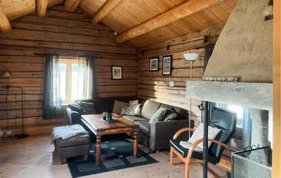 a living room with a couch and a table at Cozy Home In Fåvang With Wifi in Favang