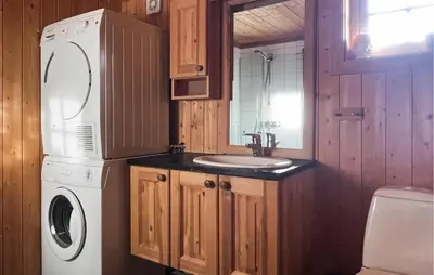 a kitchen with a sink and a washer and dryer at Cozy Home In Fåvang With Wifi in Favang