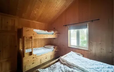 a room with two bunk beds and a window at Cozy Home In Fåvang With Wifi in Favang