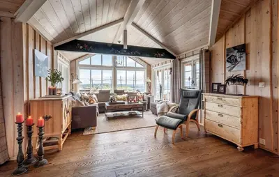 a living room with wooden walls and a large window at 4 Bedroom Stunning Home In Hemsedal in Hemsedal