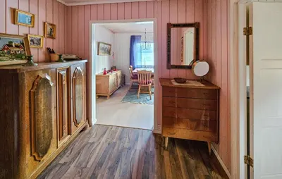a living room with pink walls and a wooden floor at 2 Bedroom Awesome Home In Vikersund in Vikersund