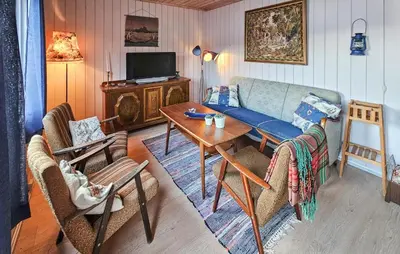 a living room with a couch and a table at 2 Bedroom Awesome Home In Vikersund in Vikersund