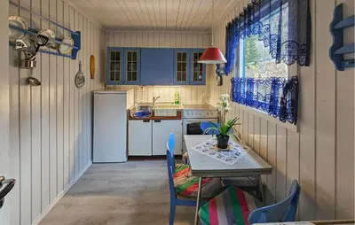 a small kitchen with a table and a sink at 2 Bedroom Awesome Home In Vikersund in Vikersund
