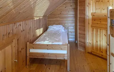 a wooden room with a bed in a sauna at 2 Bedroom Beautiful Home In Frosta