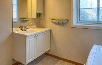 a bathroom with a white sink and a window at 2 Bedroom Beautiful Home In Frosta