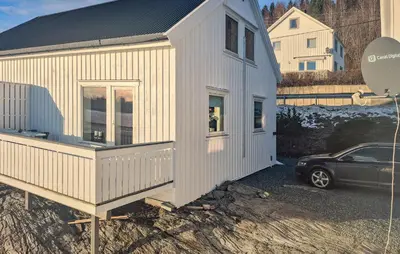 a small white house with a car parked next to it at 2 Bedroom Beautiful Home In Frosta