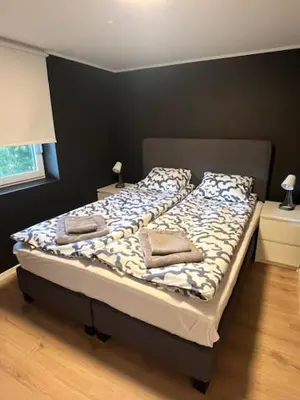 a bed with two pillows on it in a bedroom at Apartments near Bergen Airport in Bergen