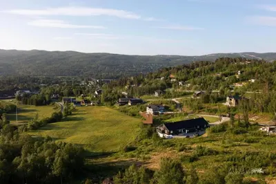 an aerial view of a small village in the hills at Cozy apartment near ski attractions in Geilo