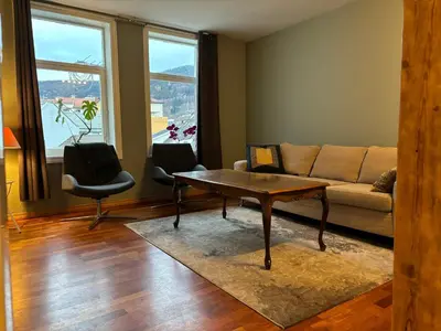 a living room with a couch and a table at Retro Apartment in Bergen
