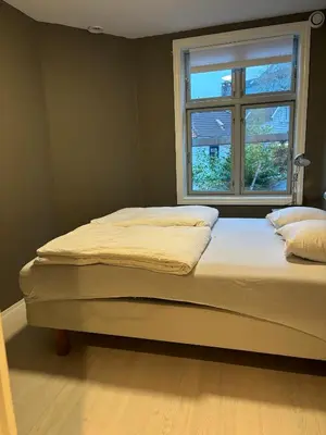 a bed in a room with a window at Retro Apartment in Bergen