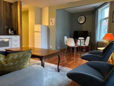 a living room with a table and chairs at Retro Apartment in Bergen