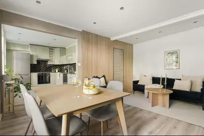 a kitchen and living room with a table and chairs at Leilighet i Sandviken in Bergen