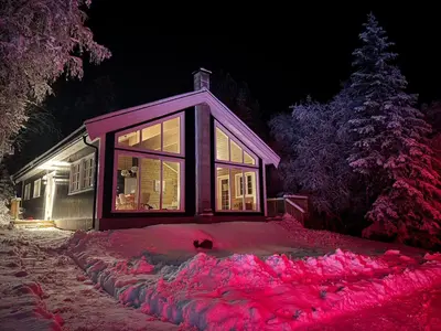a house with a lot of snow in front of it at Skogshytte på Skreia in Brattlia