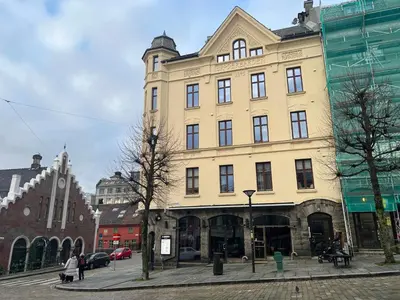 a large yellow building on a city street at Vetrlidsallmenningen 4 in Bergen