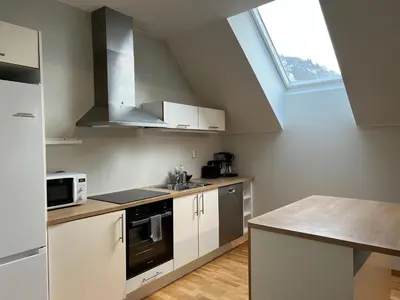 a kitchen with white cabinets and a sink and a window at Vetrlidsallmenningen 4 in Bergen